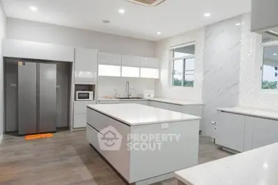 Spacious modern kitchen with sleek white cabinetry and large island