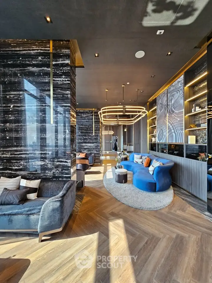 Luxurious modern living room with elegant decor and stunning lighting fixtures.
