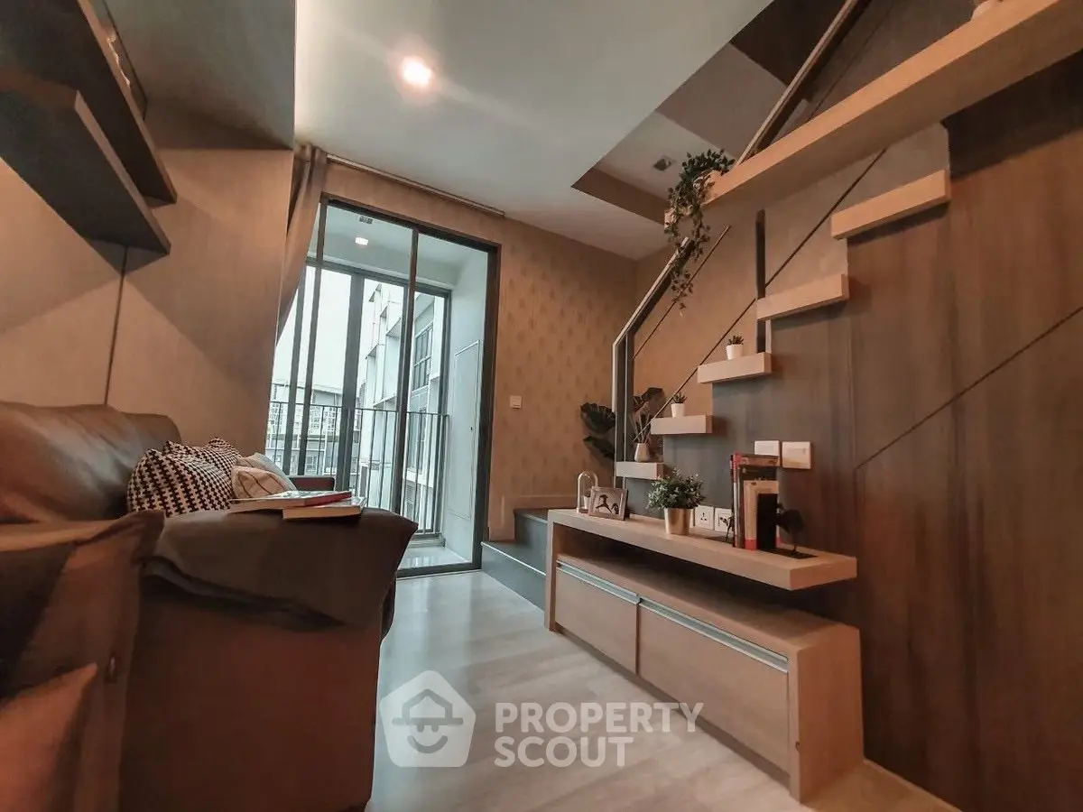 Modern living room with stylish staircase and balcony access
