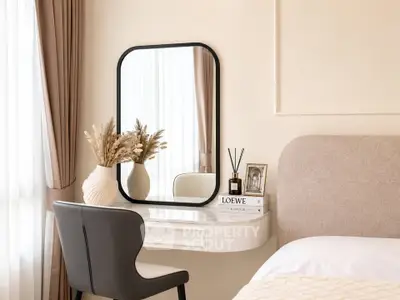 Elegant bedroom with stylish vanity, mirror, and cozy decor