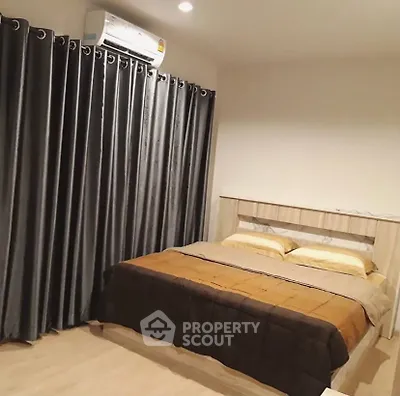Cozy bedroom with modern decor and air conditioning, featuring elegant curtains and a comfortable bed.