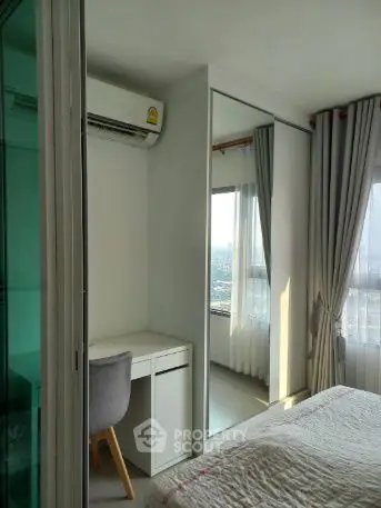 Modern bedroom with mirrored closet and city view, featuring sleek design and natural light.