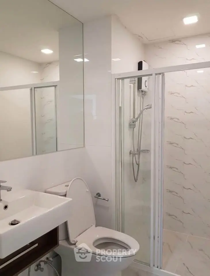 Modern bathroom with glass shower and sleek fixtures