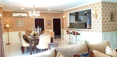 Luxurious living room with elegant dining area and open kitchen in a stylish apartment.