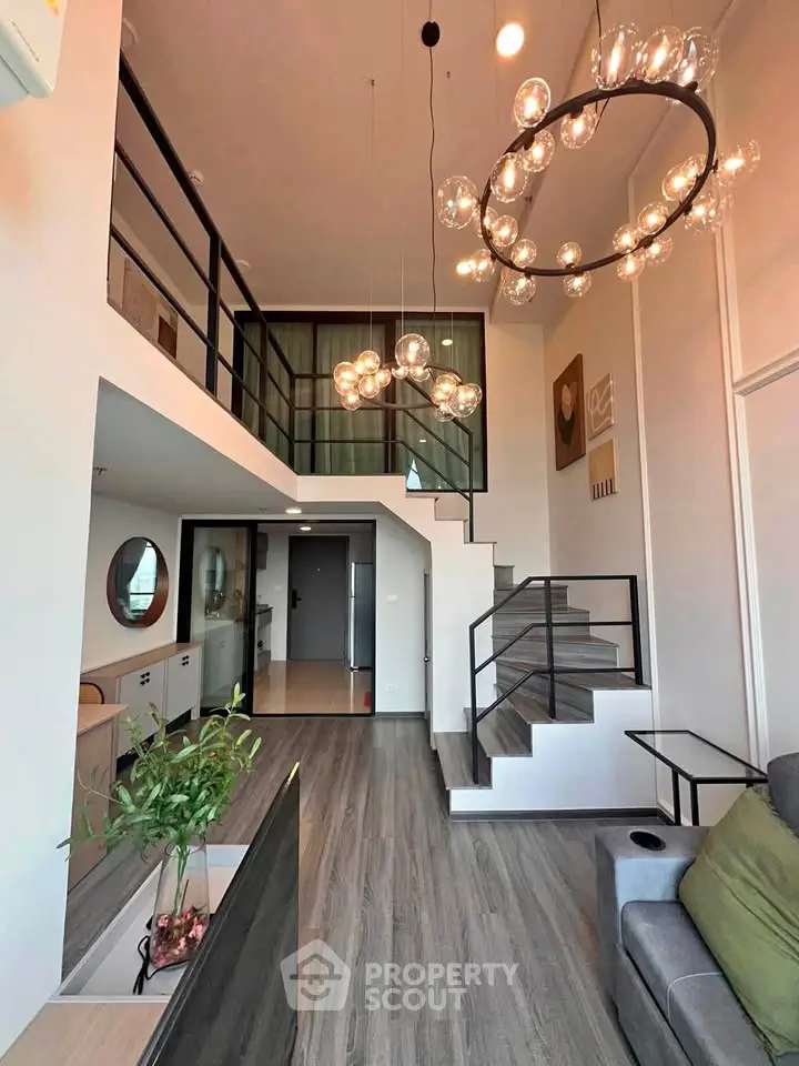Stunning modern living room with high ceilings and elegant lighting in a duplex apartment.