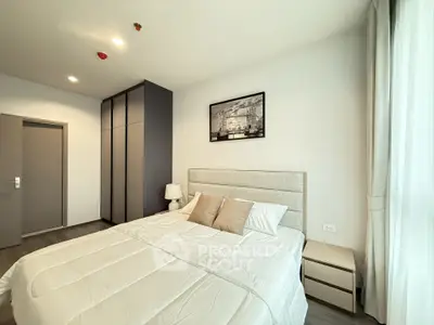 Modern bedroom with stylish decor and ample natural light