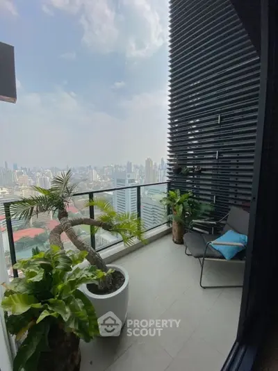 Stunning high-rise balcony with panoramic city views and lush greenery.