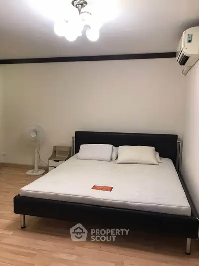 Spacious bedroom with modern bed and air conditioning