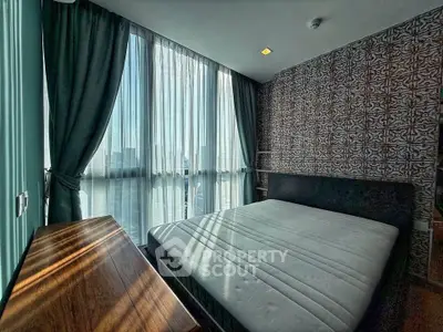 Modern bedroom with large windows and stylish wallpaper, offering a cozy and inviting atmosphere.