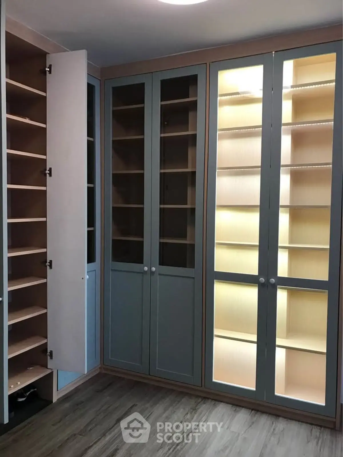 Spacious walk-in closet with elegant shelving and ample storage space.