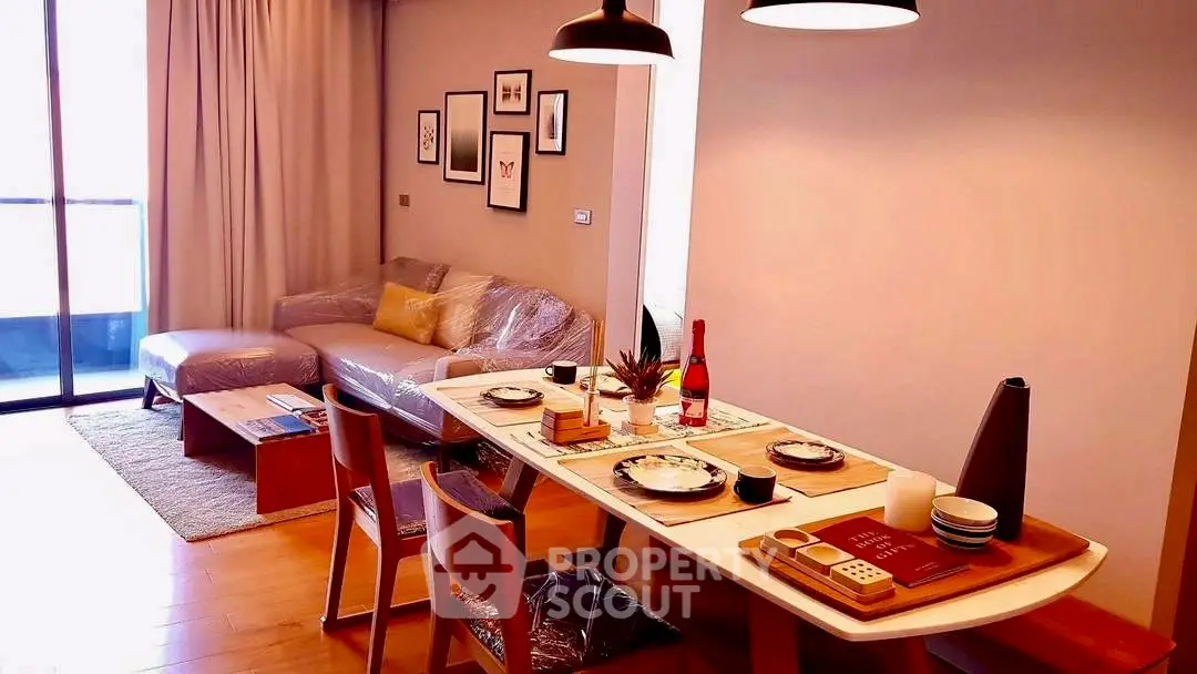 Modern living room with dining area, stylish decor, and natural light.