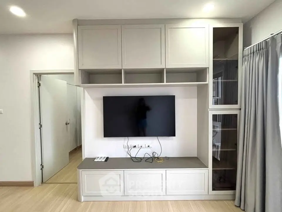 Modern living room with built-in TV cabinet and sleek design