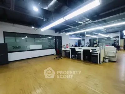 Spacious modern office interior with open layout and wooden flooring