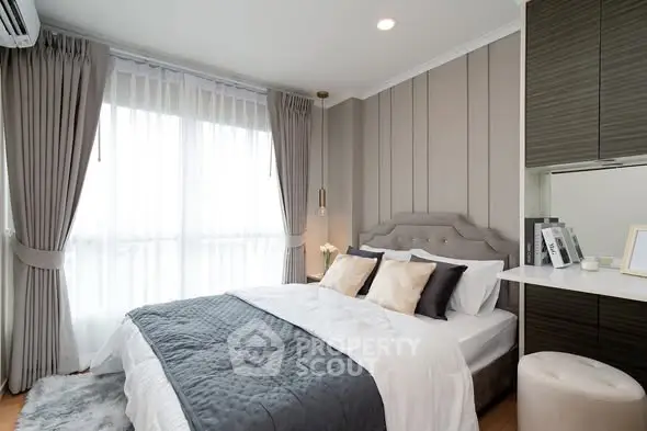 Luxurious bedroom with elegant decor and natural light, featuring a plush bed and stylish furnishings.