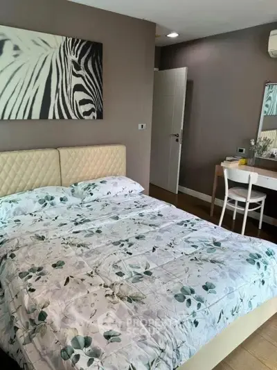 Cozy bedroom with stylish decor and comfortable bedding in modern apartment.