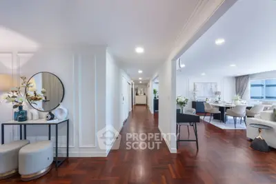 Spacious open-plan living area with elegant decor and hardwood floors