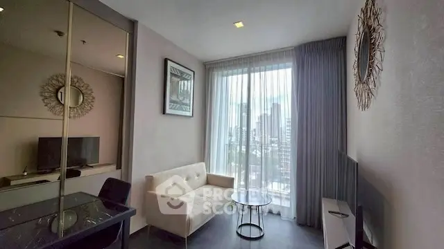 Modern living room with city view, stylish decor, and natural light.