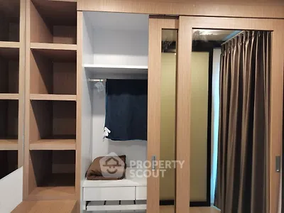 Modern wardrobe with sliding doors and open shelving in a stylish bedroom.