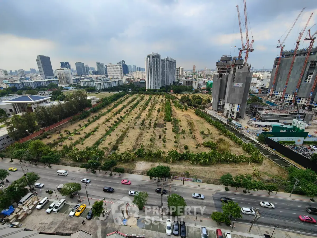 Stunning cityscape view with construction and lush greenery, ideal for urban development.