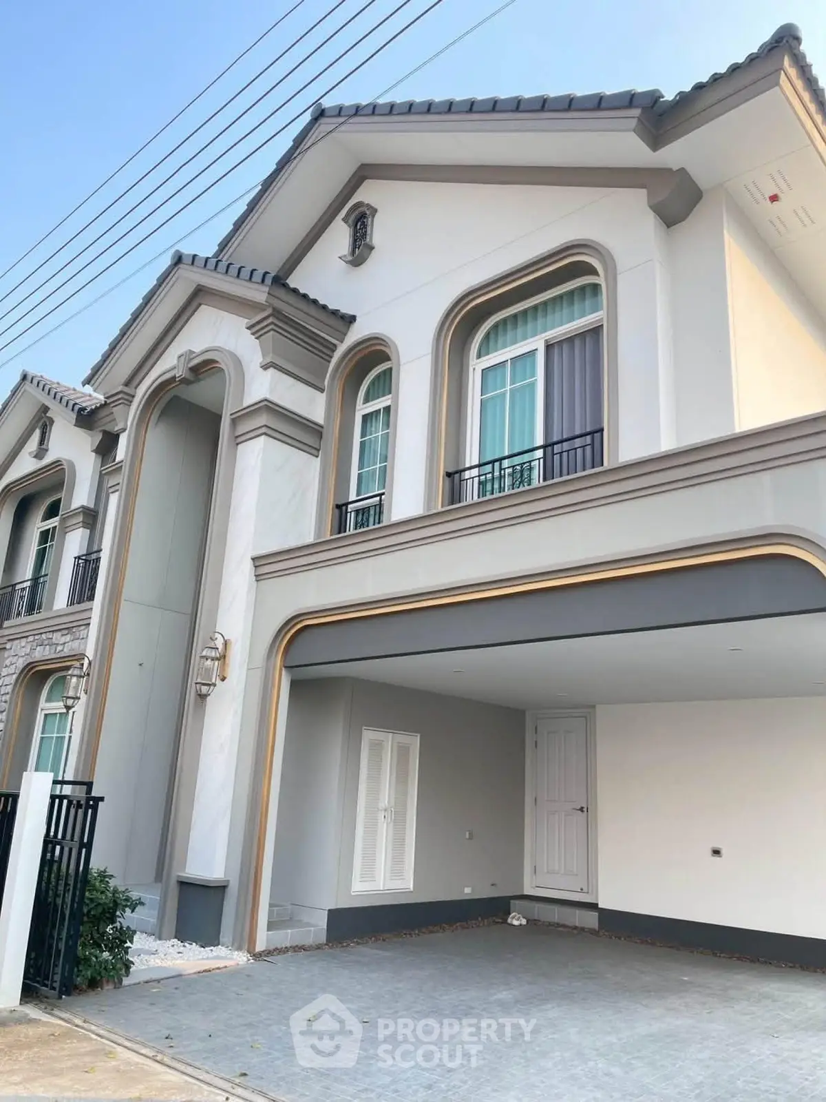 Elegant two-story house with modern facade and spacious garage in a serene neighborhood.