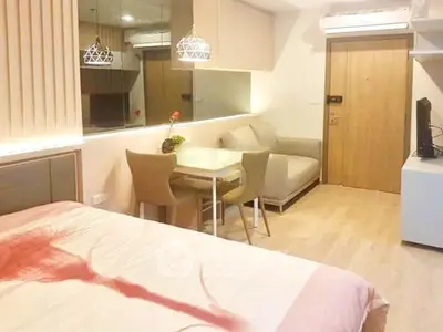 Modern studio apartment with cozy living area and stylish decor