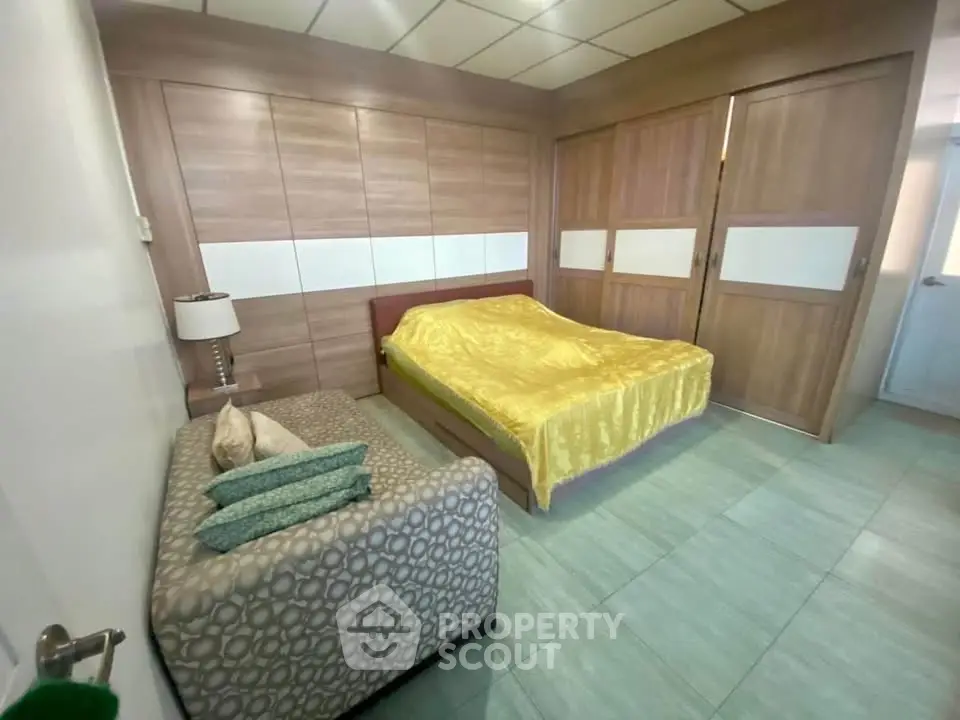 Spacious bedroom with modern design and cozy seating area