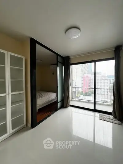 Modern apartment with glass partition and city view balcony