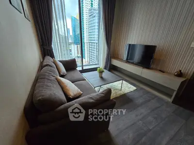 Modern living room with city view, featuring a cozy sofa and sleek TV setup.
