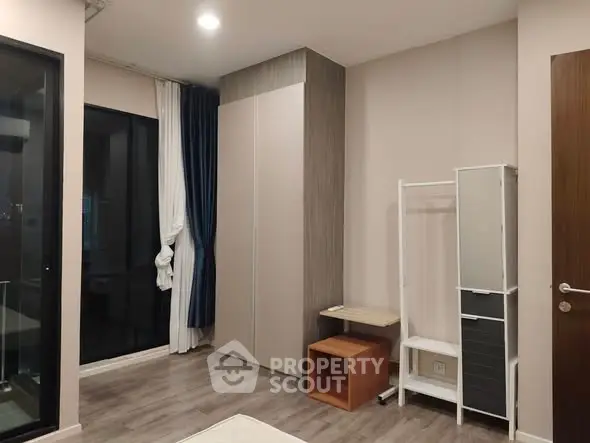 Modern bedroom with sleek wardrobe and floor-to-ceiling windows