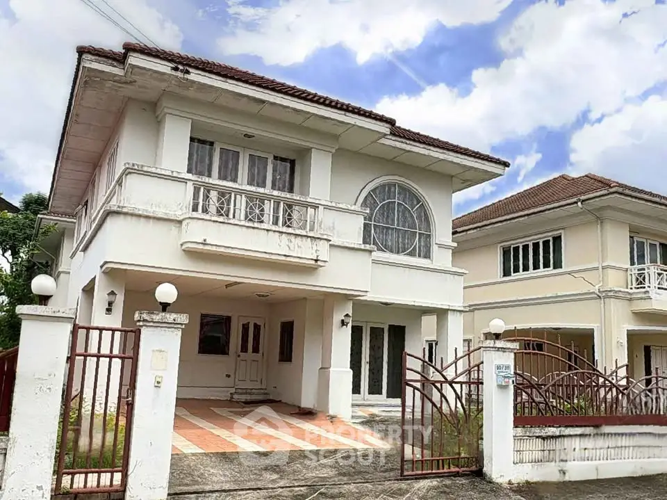 Charming two-story house with elegant balcony and spacious driveway