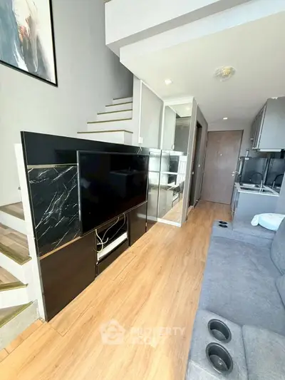 Modern duplex living room with sleek staircase and stylish decor