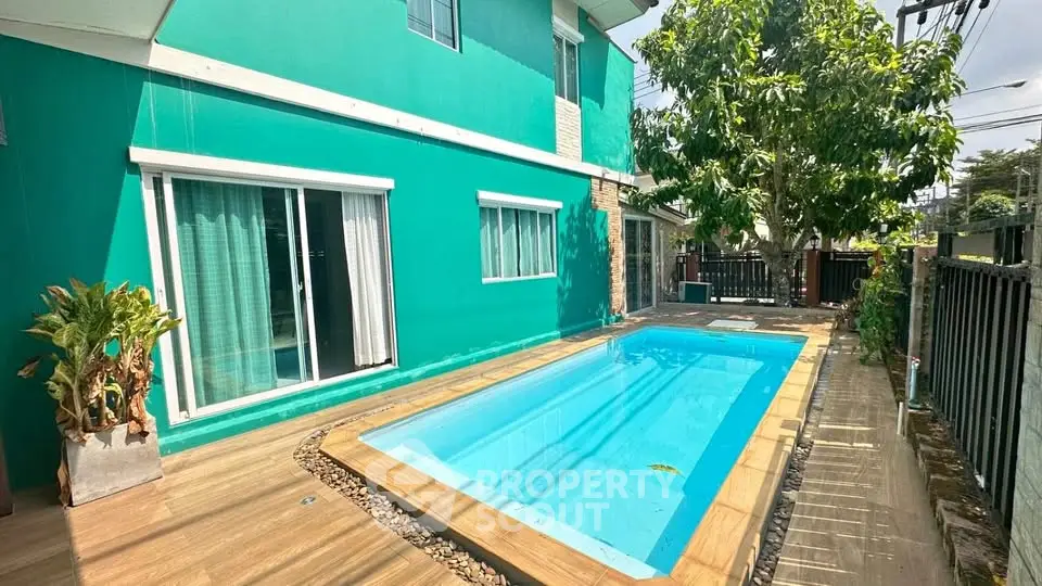 Charming turquoise house with private pool and lush greenery, perfect for relaxation and entertaining.