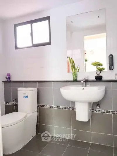 Modern bathroom with sleek gray tiles and contemporary fixtures