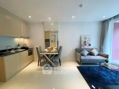 Modern open-layout kitchen and living room with stylish decor and natural light.
