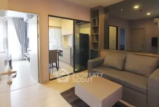 Modern living room with open kitchen and stylish decor in a cozy apartment.