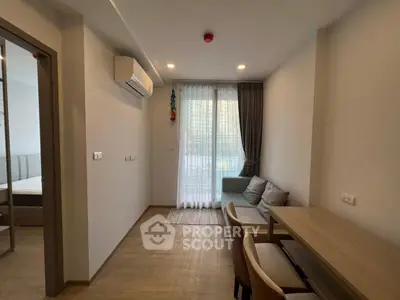 Modern living room with cozy seating and dining area, featuring natural light and stylish decor.
