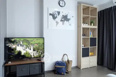 Modern living room with stylish shelving and wall-mounted TV, perfect for cozy relaxation.