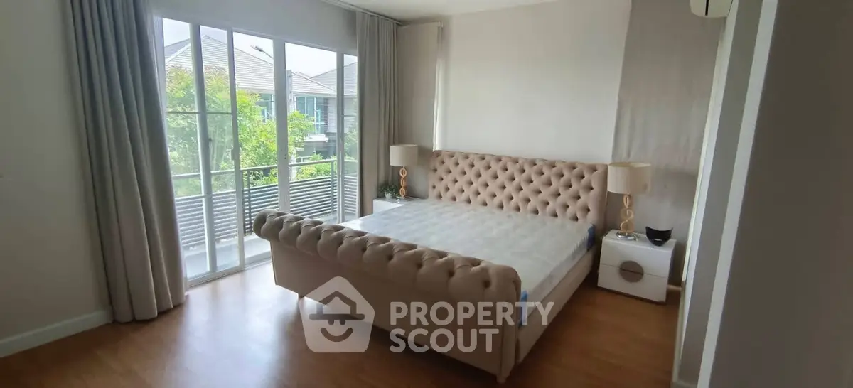 Spacious bedroom with elegant bed and large window view