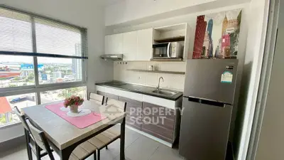 Modern kitchen with city view, featuring sleek cabinets, dining table, and large window for natural light.
