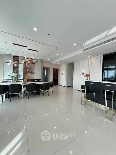 Luxurious open-plan dining and living area with modern decor and elegant furnishings.