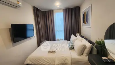 Cozy modern bedroom with wall-mounted TV and stylish decor