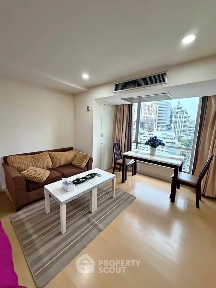 Bright living room with city view, cozy sofa, and elegant decor in modern apartment.