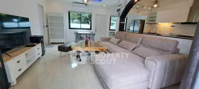 Spacious modern living room with stylish furniture and open kitchen layout, perfect for family gatherings.