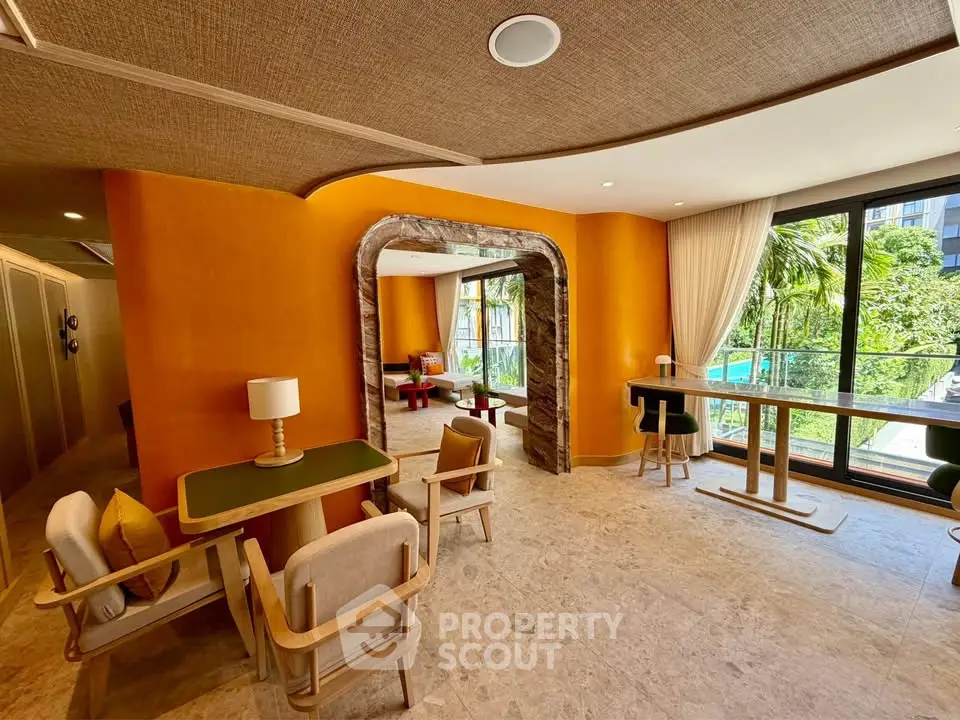 Luxurious modern living room with vibrant orange walls and large windows overlooking a lush garden and pool.
