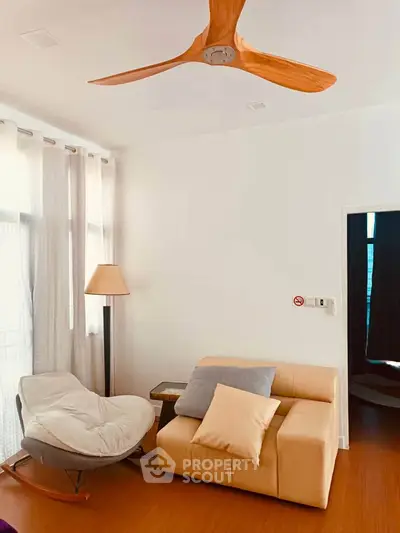 Cozy living room with modern furniture and wooden ceiling fan