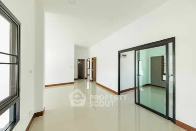 Spacious modern interior with glossy floors and large windows in a minimalist design.