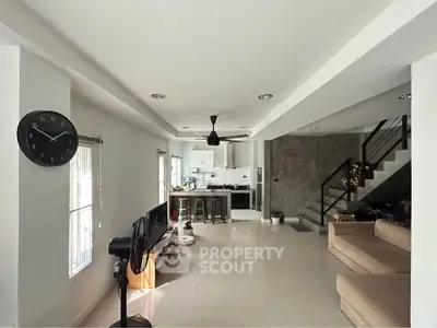 Spacious open-plan living room with modern kitchen and stylish decor