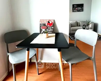 Cozy dining nook with modern chairs and table, perfect for intimate meals in a stylish apartment.