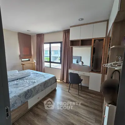 Modern bedroom with stylish decor and ample natural light
