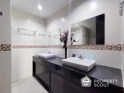 Modern bathroom with dual sinks and elegant tile design